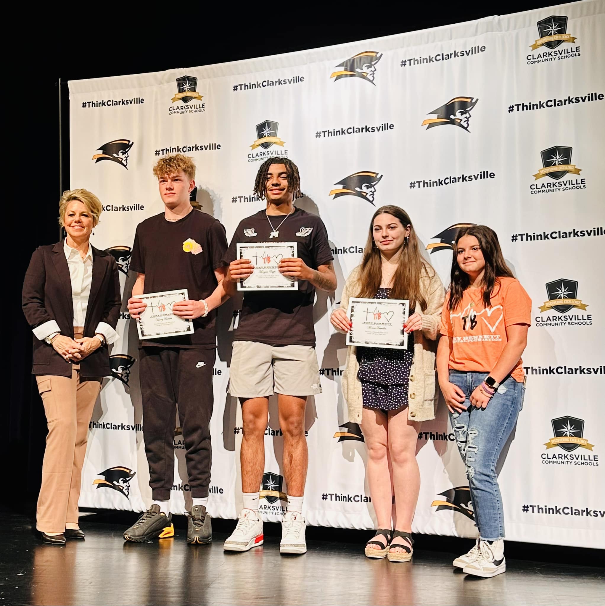 Clarksville students accepting scholarship.